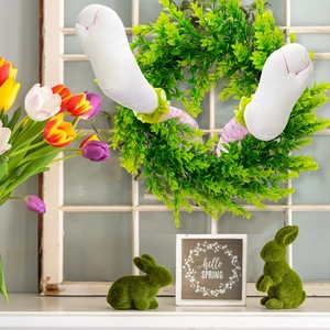 Close-up of Easter bunny legs wreath with polka dots on a vintage window frame decoration
