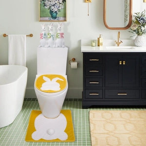 Close-up of yellow Easter toilet seat cover and U-shaped rug with white bunny silhouette