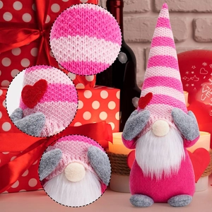 Detail of pink Valentine gnome showing knitted fabric texture and red heart ornament