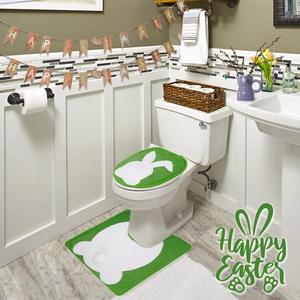Detail of soft green Easter toilet cover and U-shaped rug with white rabbit silhouette