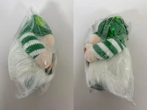 Detail of St. Patrick's Day green sequin gnome plush with clover hat in packaging