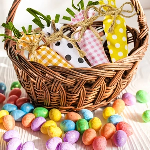 Easter fabric carrot gift bags with plaid and dot prints in a rustic wicker basket