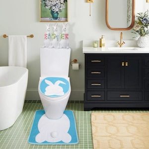 Detail of blue Easter bathroom set with white rabbit silhouettes and fluffy pom-pom tails