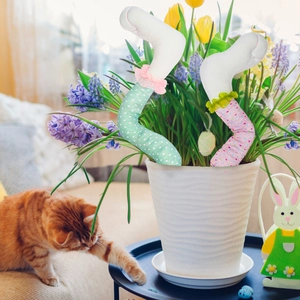 Detail of plush bunny legs with white polka dots and lace trim in a decorative flower pot