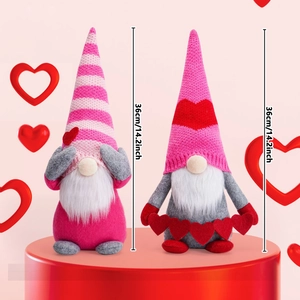 Pair of Valentine's pink gnome plushies with knitted hats and heart decor on a red stand