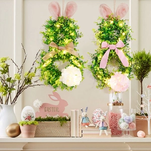 Detail of Easter bunny wreaths with warm LED lights and artificial green foliage decor