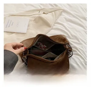 Interior view of brown PU leather bag showing spacious compartments and metal chain