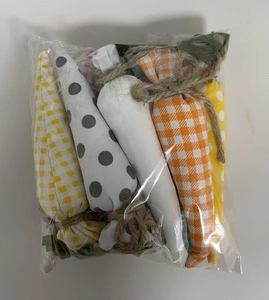 Detail of fabric Easter carrots set with plaid and polka dot prints and jute rope twine
