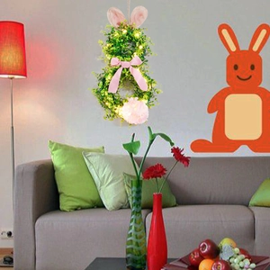 Detail of lit Easter rabbit wreath with plush ears, pink bow and glowing LED lights