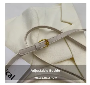 Detail of adjustable leather strap with premium gold metal buckle for woven bucket bag
