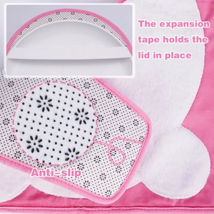 Detail of pink plush toilet cover featuring elastic expansion tape and anti-slip backing