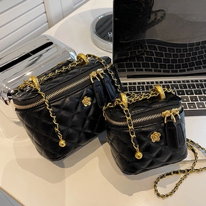 Quilted black leather bucket bags in two sizes with gold camellia and chain strap