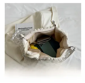 Interior view showing the large capacity and organized compartments of the cream tote bag