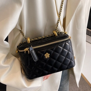 Classic black quilted crossbody bag with golden camellia ornament and chain strap