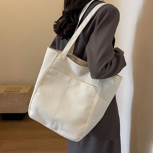 Bolso tote de lona blanca minimalista con bolsillo frontal grande y espacioso para el diario