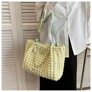 Detail of light green bubble texture tote bag with pearl chain and leather strap