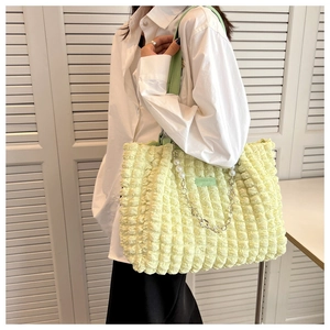 Detail of light green bubble texture tote bag with pearl and metal chain decoration