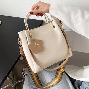 Minimalist beige large tote bag for women with floral charm and striped shoulder strap