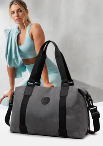 Detail of grey cylinder fitness bag with black straps and round logo on a grey background
