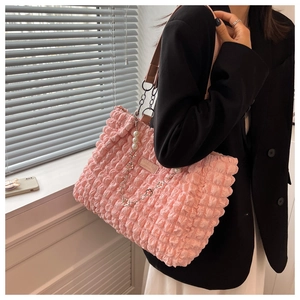 Close-up of pink cloud tote bag featuring bubble texture and decorative white pearls