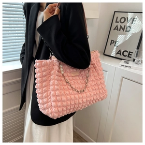 Detailed shot of pink bubble texture tote bag with silver chain and pearl flower charms