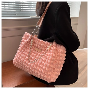 Close-up of pink bubble texture tote bag featuring a pearl and silver flower chain