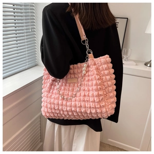Detail of pink cloud tote bag with bubble pleat texture and elegant pearl chain