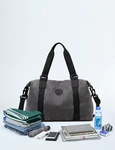Macro shot of large dark grey travel bag showing spacious capacity for clothes and camera