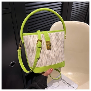 Close-up of woven texture and lime green leather stitching on the bucket bag