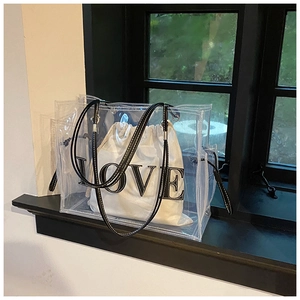 Detail view of transparent PVC tote bag with a white canvas LOVE print inner pouch
