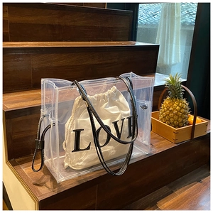 Detail view of transparent PVC tote with white canvas insert and LOVE print design