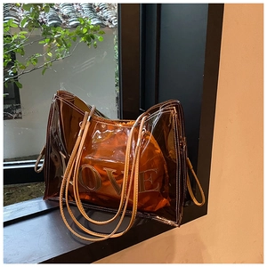 Detail of amber transparent tote with LOVE print and orange drawstring inner bag