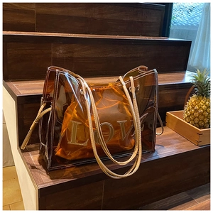 Detail of transparent amber tote bag with removable LOVE drawstring inner pouch