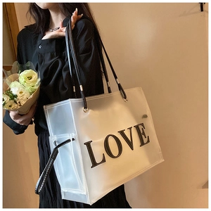 Detail view of large capacity frosted tote bag with LOVE print on minimalist shoulder strap