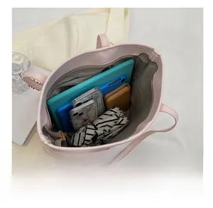 Top-down view of spacious pink tote bag showing internal zipper pocket and daily essentials