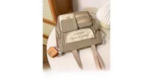 Detail view of khaki Oxford tote bag with multiple pockets and cute bread shaped charm