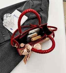 Interior view of red tote bag with large capacity, compartments, and woven handles