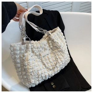 Detail of off-white cloud tote bag featuring bubble texture and pearl chain charms