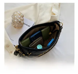 Detailed interior of the black quilted chain bag showing large storage capacity for essentials