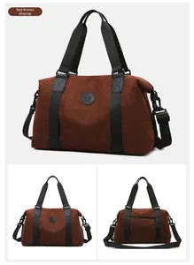 Detail of reddish brown large travel bag with nylon straps and circular logo