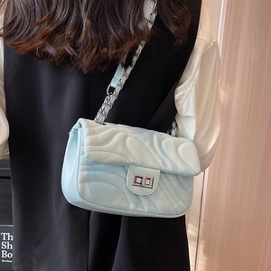 Glacier blue quilted chain crossbody bag with silver twist lock and wavy pattern