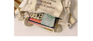 Interior view showing the large capacity of this off-white tote bag for iPad and daily items