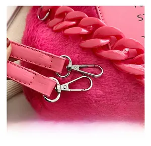 Detail of rose red faux fur tote bag with metal lobster clasp and chunky chain handle