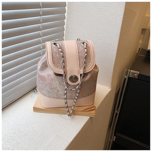 Detail of vintage pink floral backpack with silver twist lock and chain strap