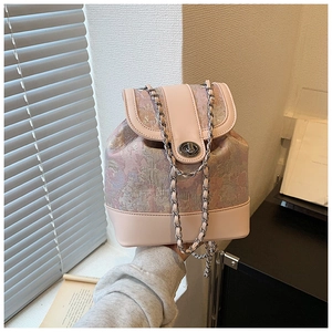 Detail of vintage jacquard fabric bucket bag with silver chain and twist lock closure