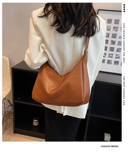 Detailed back view of a large caramel PU leather slouchy hobo bag with wide shoulder strap