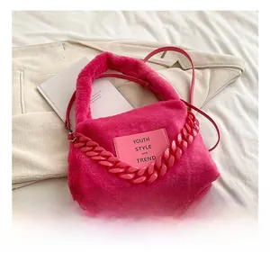 Detail of fluffy rose red plush tote bag featuring thick resin chain and faux fur texture