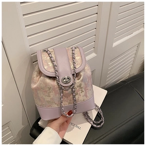 Detail of lavender lilac jacquard bucket backpack with silver metal twist lock