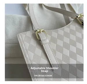 Detail of adjustable strap and golden buckle on beige quilted shoulder tote bag