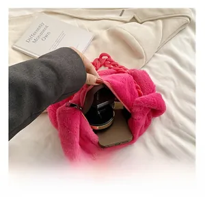 Pink plush tote bag interior showing large capacity for phone and cosmetics with zipper